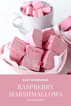 raspberry marshmallows on a plate next to a cup of coffee