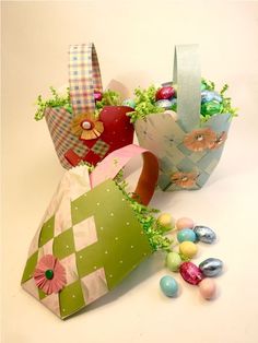 three bags with easter decorations on them sitting next to some eggs and candies in it