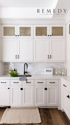 white cupboards, white cabinets, white counter, white kitchen, timeless kitchen, kitchen design, tile backsplash, white tile, bread box, kitchen decor, home decor, kitchen mat, floor mat, kitchen rug, wood flooring, dark wood, black faucet, kitchen sink, basement kitchen, kitchen design, new kitchen, home decor, interior design, White Kitchen Decor Ideas, Dark Kitchen Floors, White Kitchen Cupboards, White Cabinets White Countertops, Modern White Kitchen, Wood Floor Kitchen, Basement Kitchen, Project Portfolio