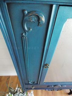 an old blue cabinet with metal handles and knobs