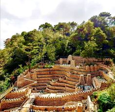 an aerial view of a castle like structure surrounded by trees