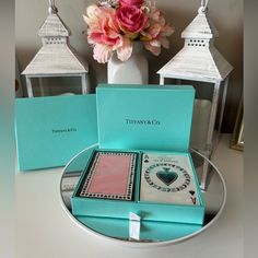 a table topped with two boxes and a vase filled with flowers