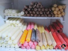 an assortment of fruits and vegetables are on display in a refrigerator, including carrots