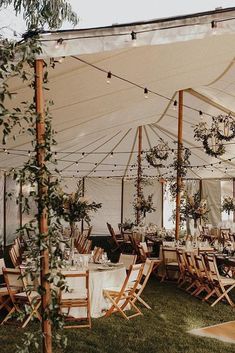 an outdoor tent set up with tables and chairs