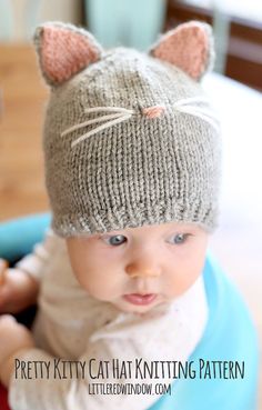 a baby wearing a knitted cat hat