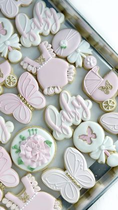 decorated cookies in pink and white on a tray