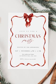 a christmas party card with a red bow on it, surrounded by cinnamon sticks and greenery