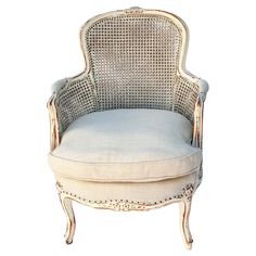 an old chair with a white cushion on it