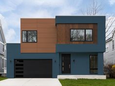 a two story house with brown and blue siding