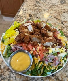 a large salad with dressing on the side