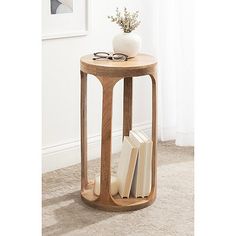 a small wooden table with books on it