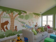 a living room filled with lots of furniture and walls painted in animal themed paint on the walls