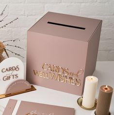 two cards and a candle on a table next to a box with the words cards and well wishes written on it