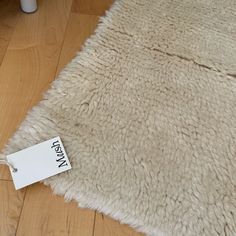 a white rug on the floor with a price tag attached to it's side