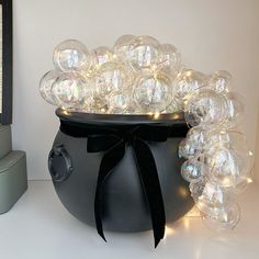 a large black pot filled with lots of bubbles on top of a white countertop