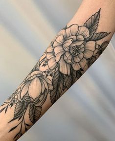 an arm with flowers and leaves on it