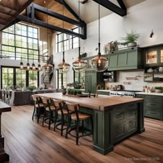 a large kitchen with wooden floors and green cabinets in the center is surrounded by windows