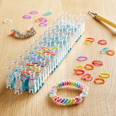 a table topped with lots of different types of bracelets and bottles filled with beads