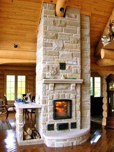 a living room with a fire place in the center and wood floors on both sides