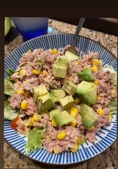 a blue and white plate topped with tuna salad