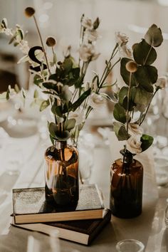 two vases filled with flowers on top of a table