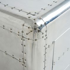 a large metal box with rivets on the top and bottom is shown in close up