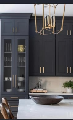 an image of a kitchen with black cabinets and white counter tops in the same color scheme