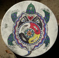 a white plate with an image of a turtle on it's face and colorful designs