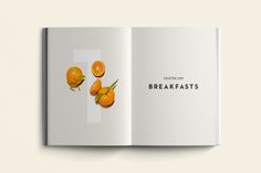 an open book with oranges on the cover and words reading breakfast is written in black