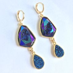 Blue Geode And Druzy Dangle Huggie Earrings ~Nwt Iridescent Blue Geode And Druzy Sparkle Like Glitter. Large Faceted Geode Gemstones Feature A Tear Drop Bezeled Druzy Dangle. Gold-Plated Bezel, Huggie Ear Wires, Resin Druzy, Geode Gemstone. Approx. Size: 2-3/8"L, 3/4"W *Gemstones Are Natural And No Two Are Alike. Shape And Color Differences Give Them Each Character. New, Nwt, Handmade By: Jpeace Designs New, Trendy, Handmade Jewelry, Droplet, Dangle Earrings, Natural Gemstone Hawaii Crafts, Sand Dollar Earrings, Coin Pearl Earrings, Michael Kors Earrings, Blue Geode, Engagement Earrings, Geode Earrings, Druzy Jewelry, Iridescent Blue