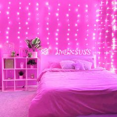 a bedroom with pink walls and lights on the wall