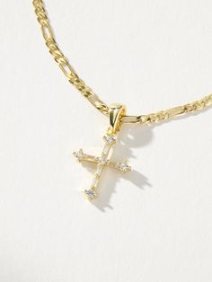 Bringing the gold and the glam is our Cross And Chain Necklace. A cross pendant hangs on a gold figaro chain to create the cross necklace everyone needs in their jewelry collection. | Gold Cross and Chain Pendant Necklace | Women's Jewelry by Uncommon James Gold Chain Women, Christian Crosses, Gold Figaro Chain, Uncommon James, Gold Watches Women, Gold Watches, Necklace Cross, Chain Women, Gold Cross Pendant