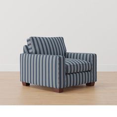 a blue and white striped chair sitting on top of a hard wood floor