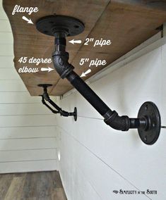 an overhead pipe is attached to the side of a wall with two different types of pipes