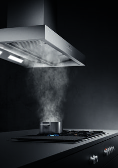 a stove top with steam coming out of it's burners and the hood is open