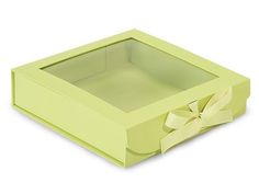 a green box with a bow on the front and inside, sitting on a white surface