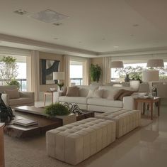 a living room filled with furniture and lots of windows