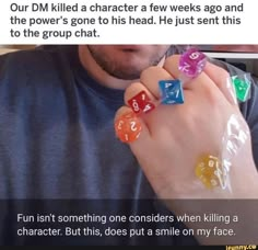 a man is holding two dices with numbers on them and the caption reads, our dm killed a character a few weeks ago and the power's one to his head just sent