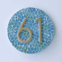 a blue and white tile with the number sixteen on it's side is shown