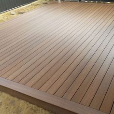 a close up of a wooden deck in the middle of construction work on a house