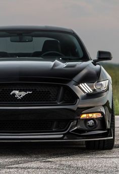 the front end of a black mustang car