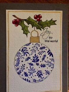 a card with a blue and white christmas ornament