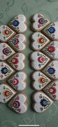 several decorated cookies are arranged on a table