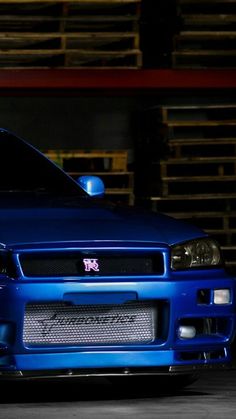 a blue sports car parked in a garage