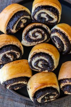 a plate filled with chocolate swirl rolls on top of a wooden table