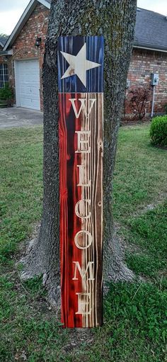 a wooden sign that is next to a tree