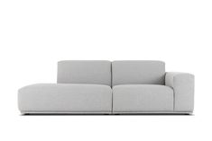 a gray couch sitting on top of a white floor