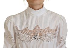 Introduce timeless elegance into your wardrobe with this stunning white blouse from Dolce & Gabbana. Perfect for any occasion that calls for a touch of sophistication, the blouse features delicate lace trim that exudes femininity. Crafted in Italy, this piece is a testament to exquisite craftsmanship and luxurious fabric blending. Material: 85% Cotton, 10% Nylon, 5% Polyester Color: White Country of origin: IT Logo details Turtle Neck Blouse, Denim Jacket Men, Dolce E Gabbana, Cotton Blouse, White Blouse, Cotton Blouses, Dolce & Gabbana, Cotton Lace, Luxury Fabrics