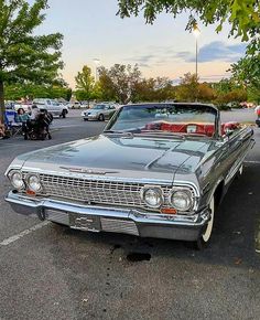 an old car parked in a parking lot