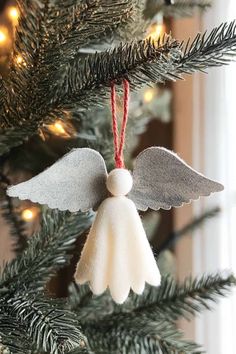 an angel ornament hanging from a christmas tree